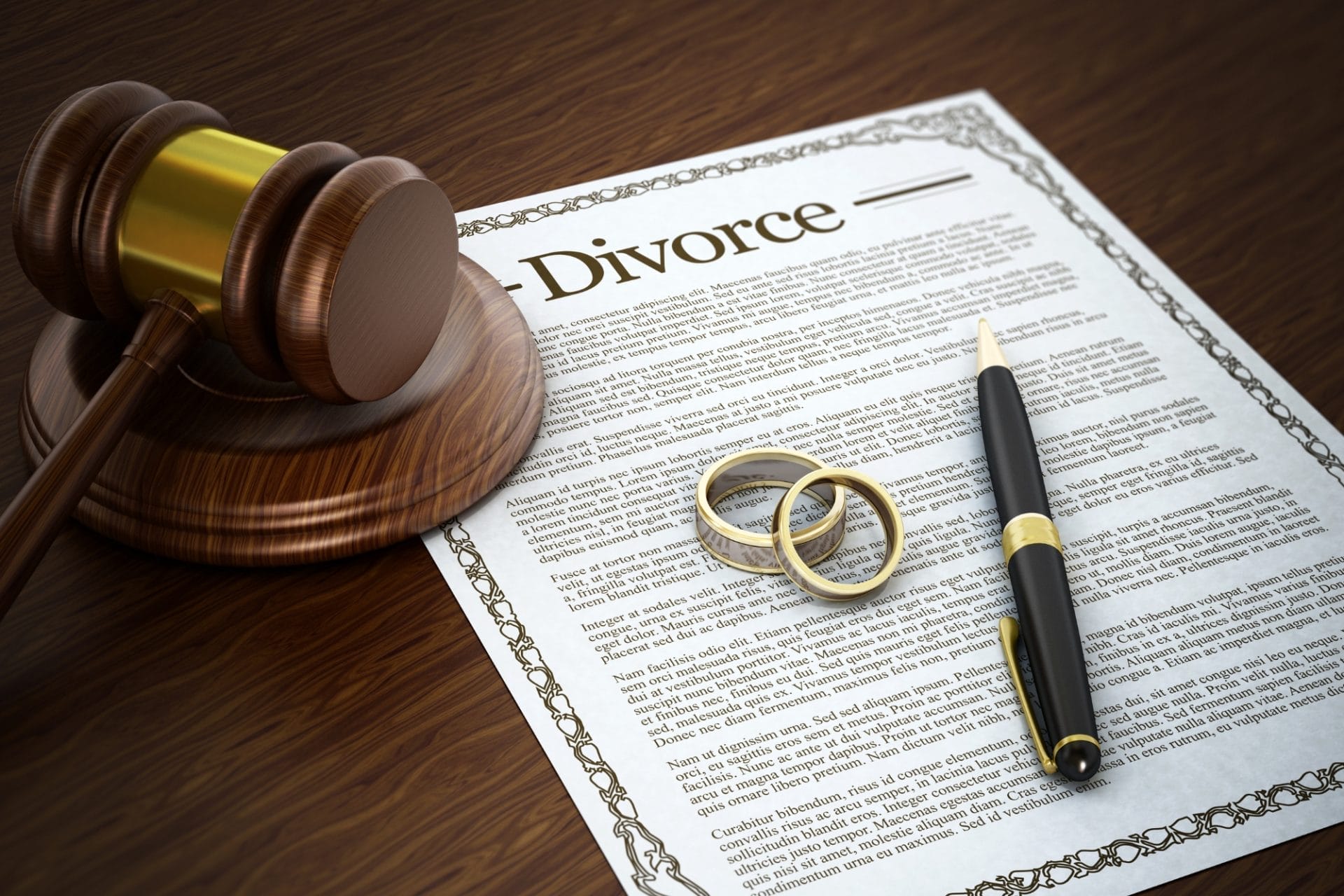 Divorce documents with wedding rings, a pen and a gavel