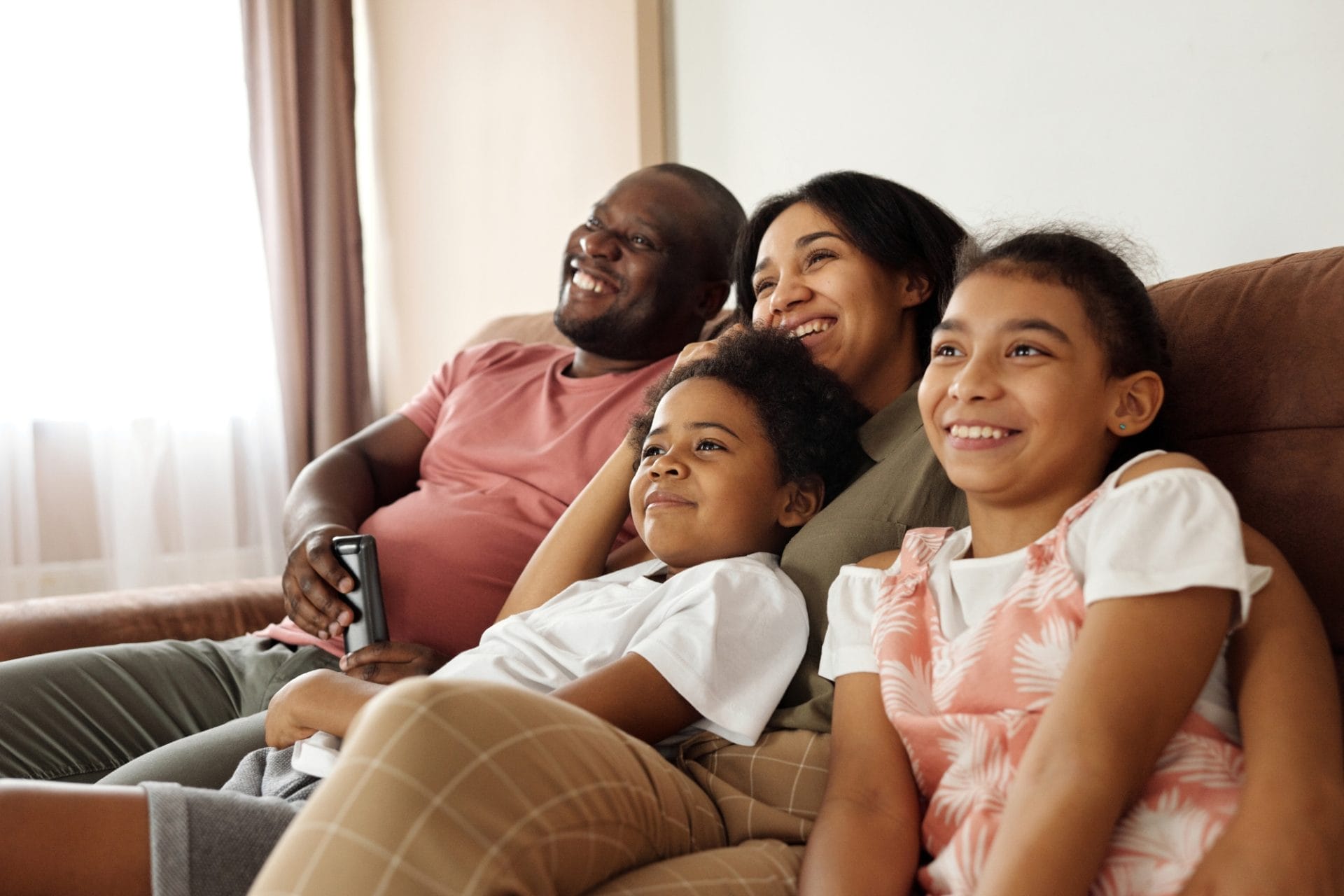 Family on couch watching television