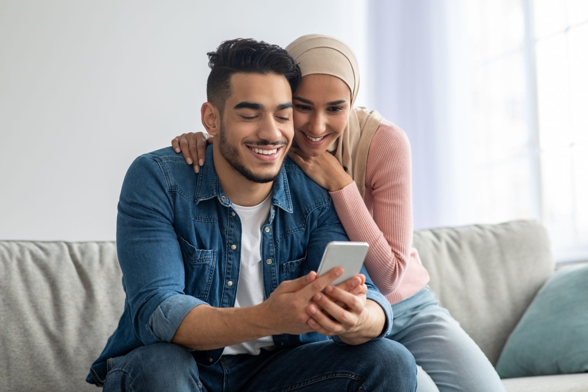A young couple reading a message
