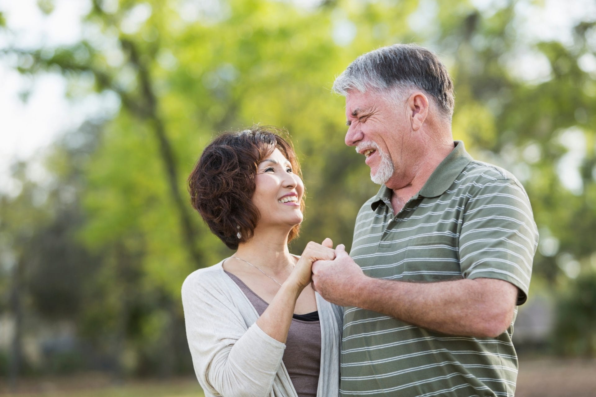Older couple holding hands outside