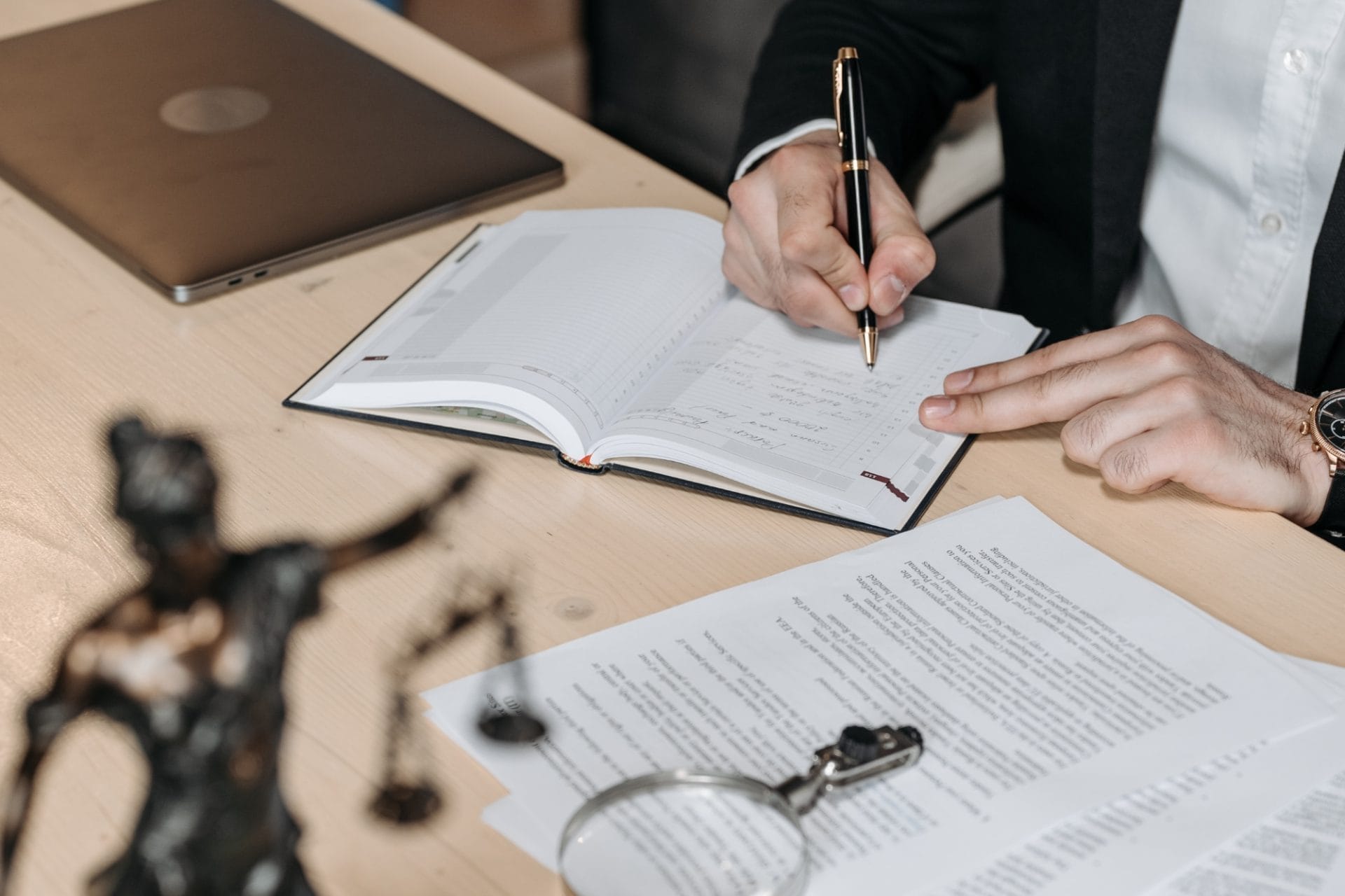 Lawyer making notes during meeting